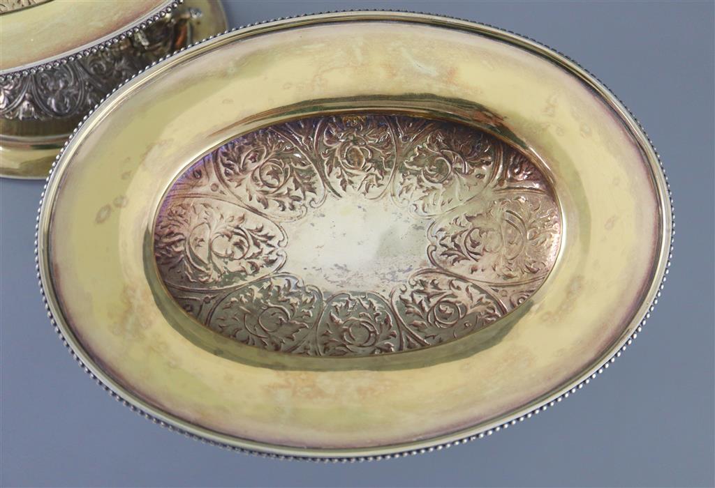A handsome pair of Victorian parcel gilt silver oval comports by Hunt & Roskell (lacking glass bowls),